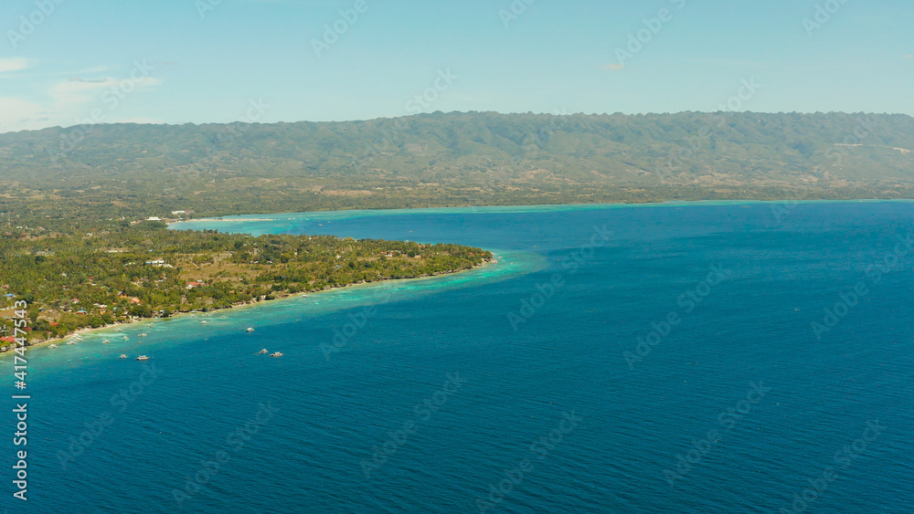 Coastline with coral reef and blue water, diving site, Moalboal, Philippines. Aerial view, Summer and travel vacation concept.