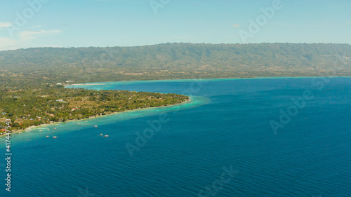 Coastline with coral reef and blue water, diving site, Moalboal, Philippines. Aerial view, Summer and travel vacation concept. © Alex Traveler
