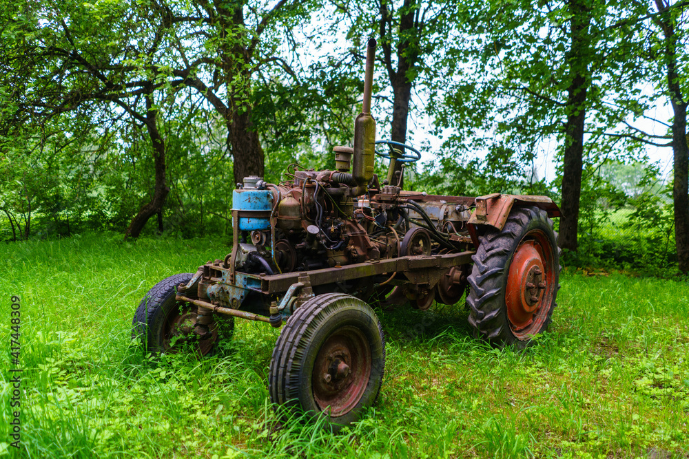 old broken tractor in the field old broken tractor in the field