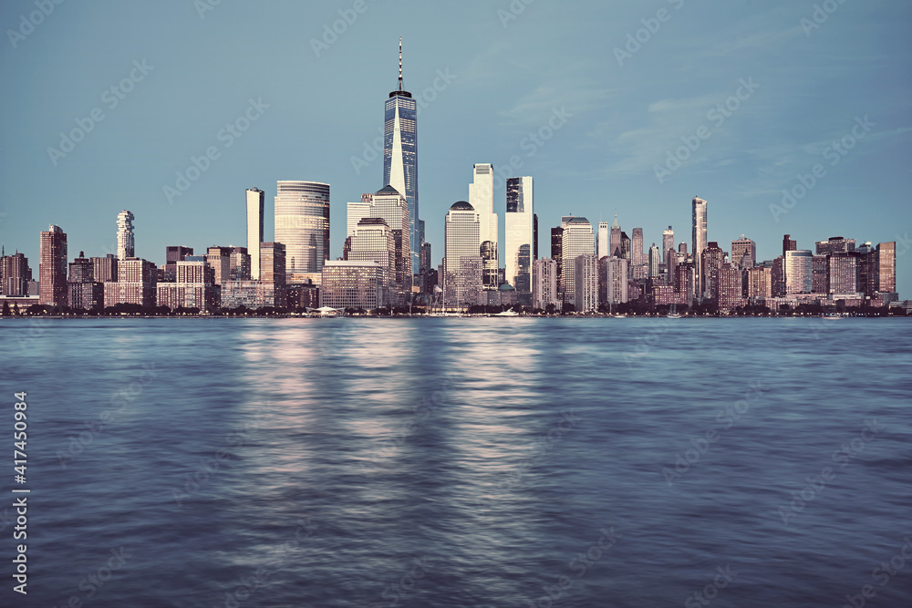 New York City skyline with buildings reflecting last sunlight, color toning applied, USA.