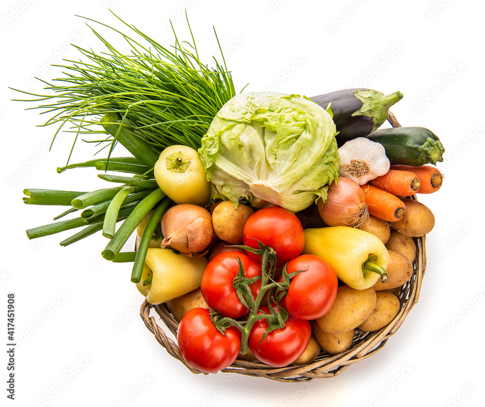 Large basket of vegetables. View from above. Potatoes, tomatoes, onions, cabbage, paprika, zucchini, eggplant. Isolate on white background Large basket of vegetables. View from above. Potatoes, tomatoes, onions, cabbage, paprika, zucchini, eggplant. Isolate on white background