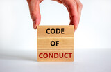 Code of conduct symbol. Concept words 'Code of conduct' on wooden blocks on a beautiful white background. Businessman hand. Business and code of conduct concept. Copy space.