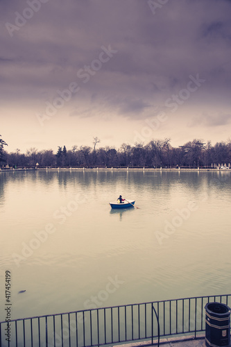 Lonely man with boat in a pond