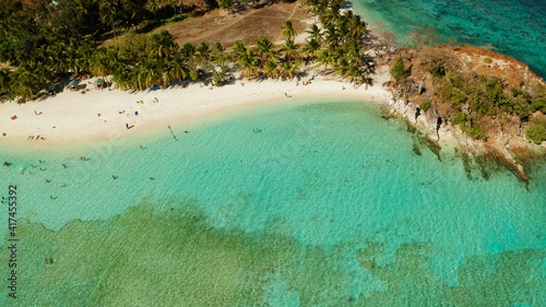 aerial seascape tourists enjoy tropical beach. tropical island with sand beach, palm trees. Malcapuya, Philippines, Palawan. Tropical landscape with blue lagoon, coral reef