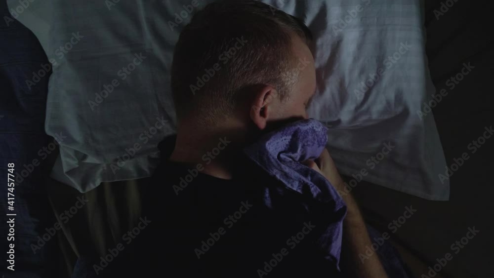 Tired Man fall to pillow and falls asleep after hard workday