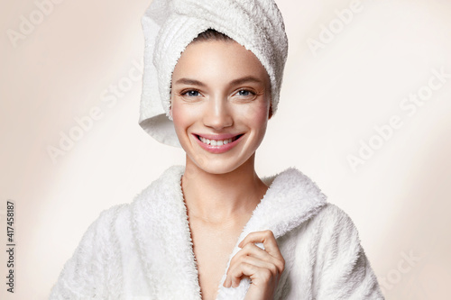 Beautiful woman after shower. Photo of woman with perfect skin on beige background. Beauty and skin care concept