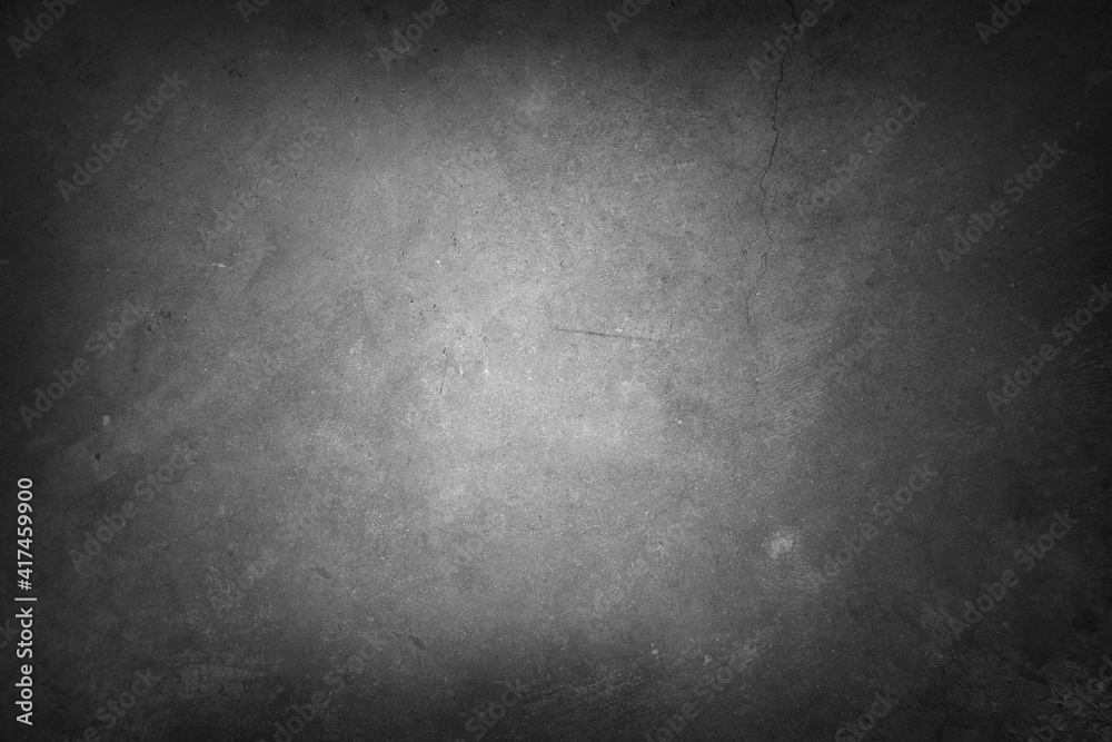 Grey textured concrete wall background. Dark edges Grey textured concrete wall background. Dark edges
