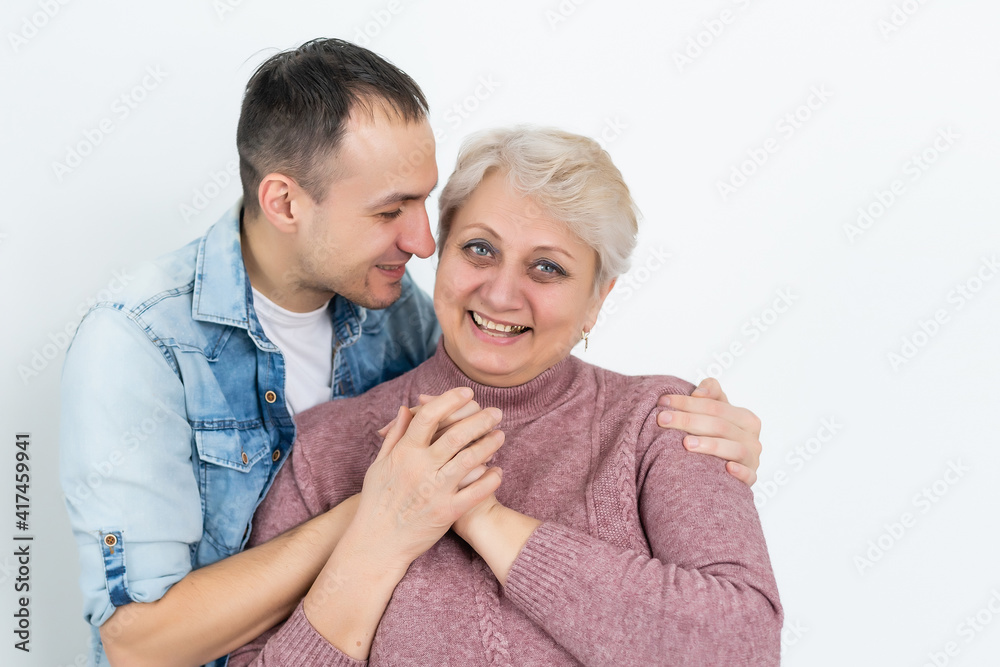 Mother and adult son together, son giving mother a kiss Mother and adult son together, son giving mother a kiss