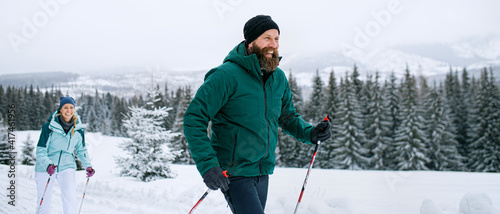 Tableau sur toile Mature couple cross country skiing outdoors in winter nature, Tatra mountains Slovakia