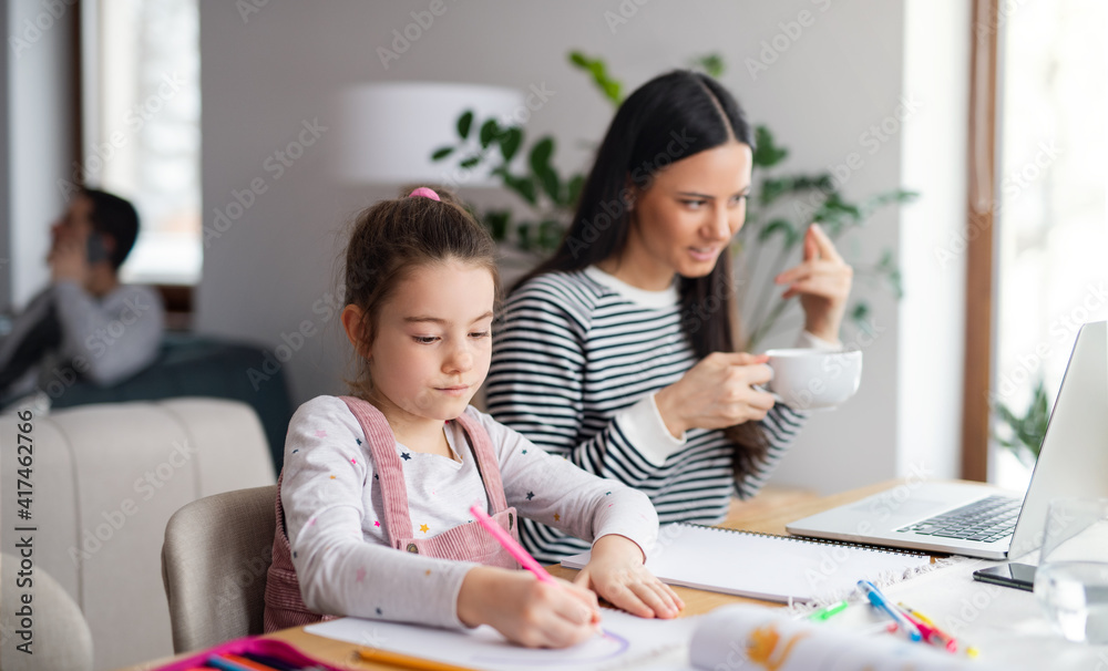 Mother with school girl indoors at home, distance learning and home office. Mother with school girl indoors at home, distance learning and home office.