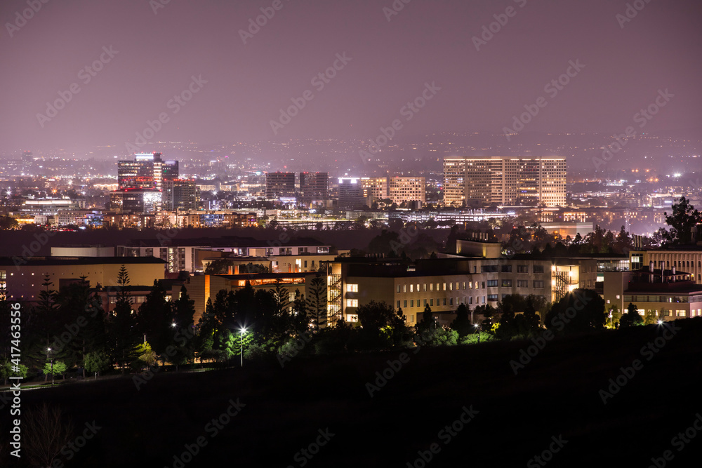 Night time view of the converging downtown skylines of Irvine, Newport Beach, Costa Mesa, and Santa Ana, California, USA.