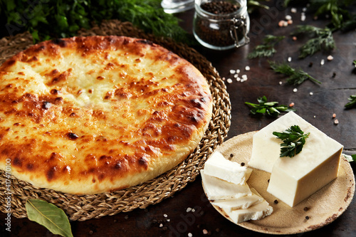 National Caucasian dish - Ossetian pies with cheese, potatoes, herbs, cottage cheese, beef, mushrooms photo