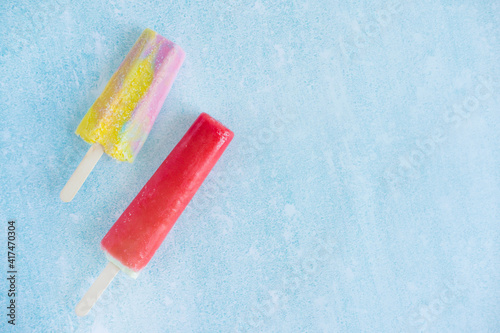 Two ice creams on a stick with place for text. Yummy ice-cream. Children's sweets, ice cream in summer