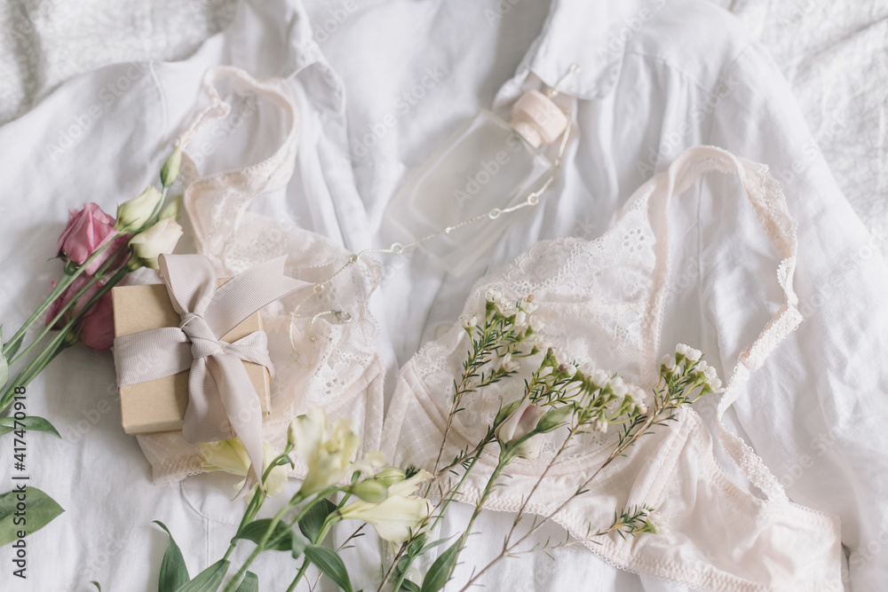 Happy Women's day. Stylish lingerie,jewelry, gift, perfume and spring flowers. Soft trendy image