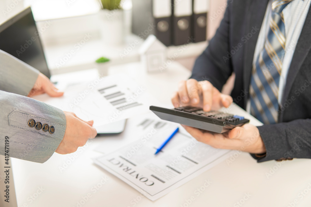 businessman counts on a calculator. partial focus. close-up. businessman counts on a calculator. partial focus. close-up.