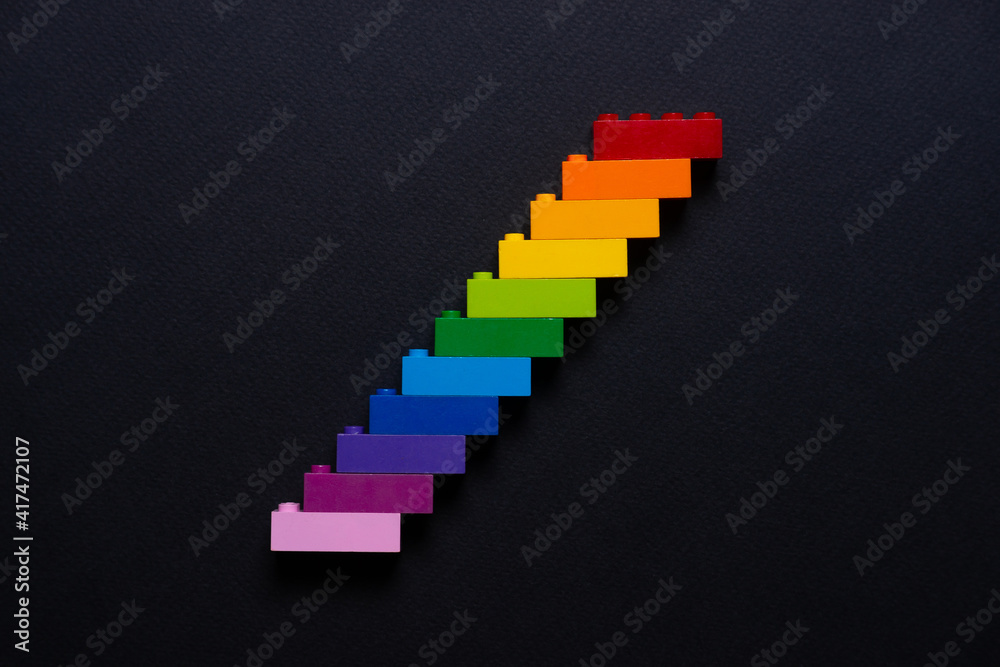 children's construction set, plastic blocks of the construction set are connected in the order of the colors in the rainbow children's construction set, plastic blocks of the construction set are connected in the order of the colors in the rainbow