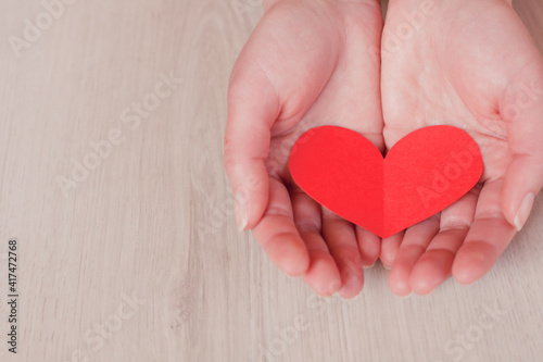 Hands holding red heart, health care, love, organ donation, mindfulness, wellbeing, family insurance and CSR concept, world heart day, world health day, National Organ Donor Day.