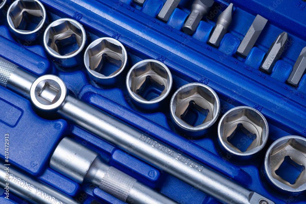 professional set of ratchets and sockets with tool steel bits with added vanadium and chrome on a white background. A set of tools in a portable plastic case