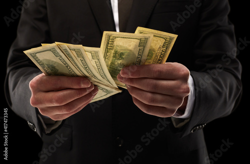 business concept, counting money on black background