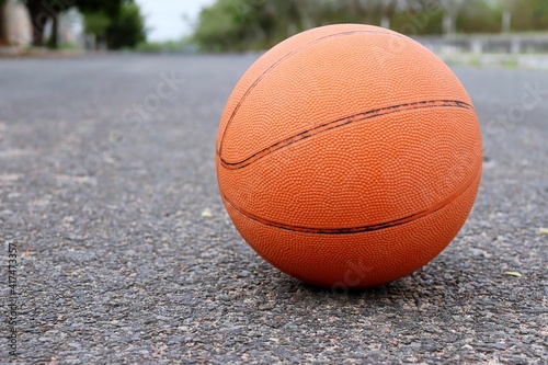 Basketball ball laying in the street.  © Brenda Blossom