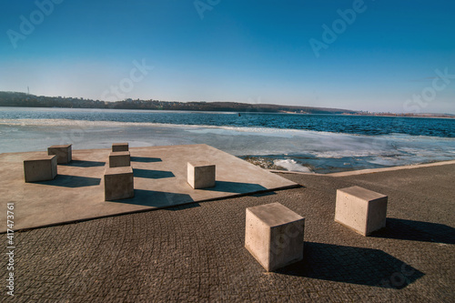 abstraction from cubes on the waterfront and melted ice on the pond in early ...