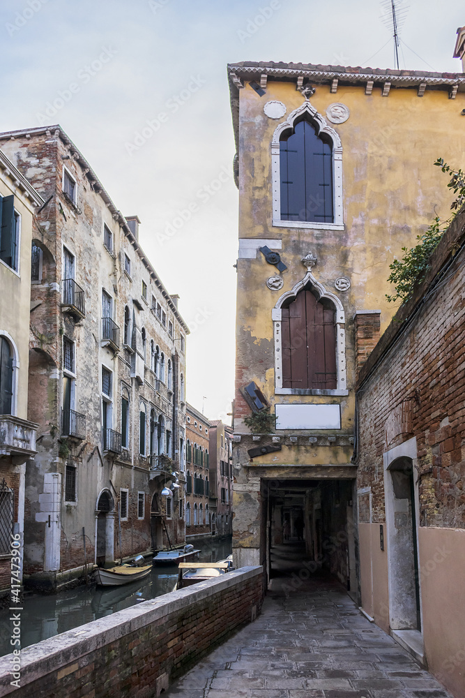 View of old traditional buildings located near the canal. Venice, Italy.