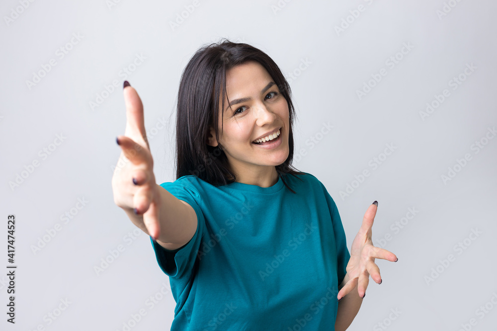 Portrait of attractive young woman wants to hug you, isolated on grey background. Portrait of attractive young woman wants to hug you, isolated on grey background.
