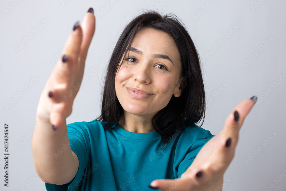 Portrait of attractive young woman wants to hug you, isolated on grey background. Portrait of attractive young woman wants to hug you, isolated on grey background.