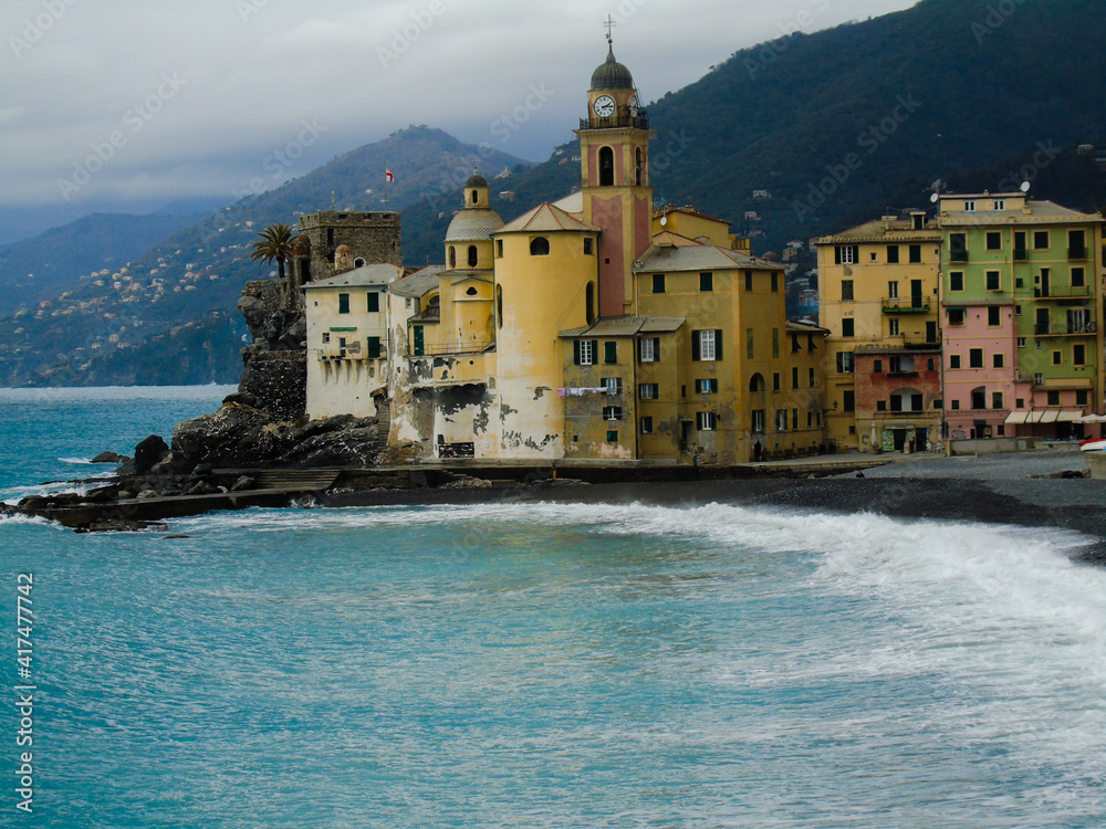 Liguria, Italy - March, 01, 2021 - Old buildings and bridges from the small Ligurian villages. Roman and medieval architecture with seaside in the background. Beautiful landscape of a coastal fishing.