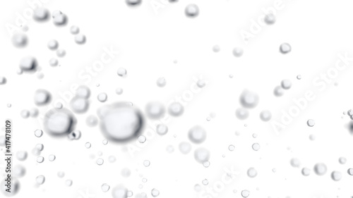 Water droplets are falling on a light background. Macro shot with shallow depth of field.
