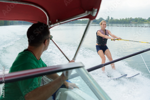 woman training on waterskis along a boat