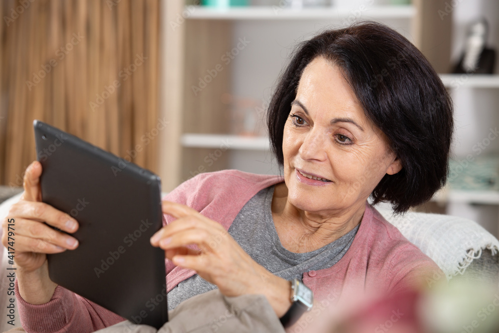 senior woman at home using a tablet senior woman at home using a tablet