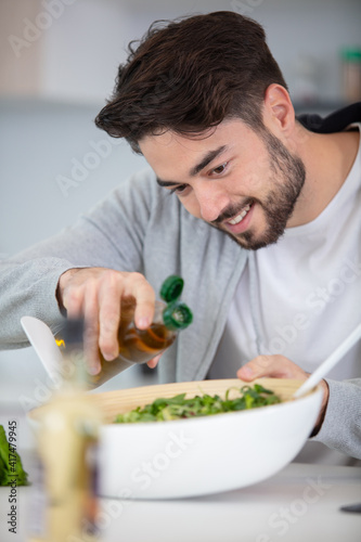 young man eating a healthy salad
