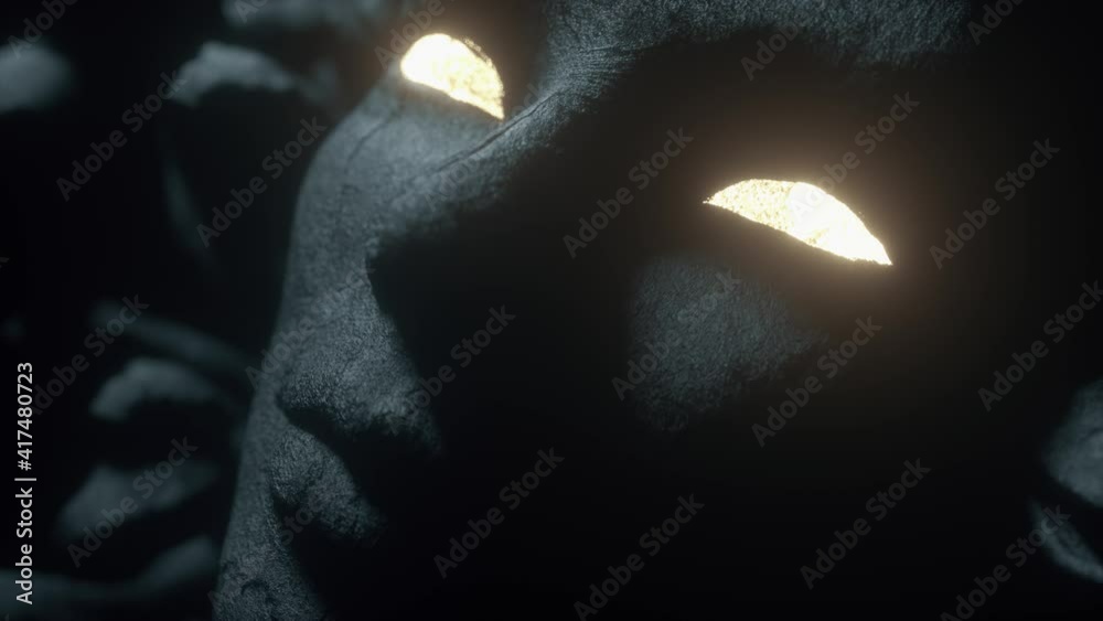 Antique stone female head sculpture isolated on black background. Ancient sculpture of the goddess Medusa. Open glowing eyes, light up with a bright light. Close-up, depth of field. 3d animation of 4K