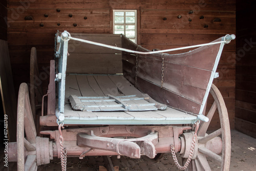 Old wooden antique wagon in a barn