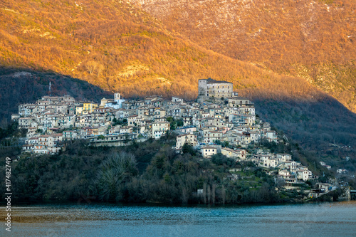 castel di tora al tramonto, paesino costruito a picco sul lago artificiale del turano photo