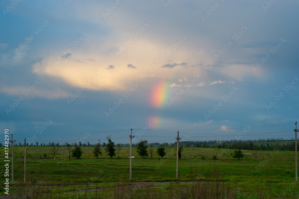 Fototapeta premium natural phenomenon - a beautiful rainbow in the sky after rain