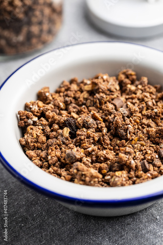 Chocolate breakfast cereal. Morning granola in bowl.