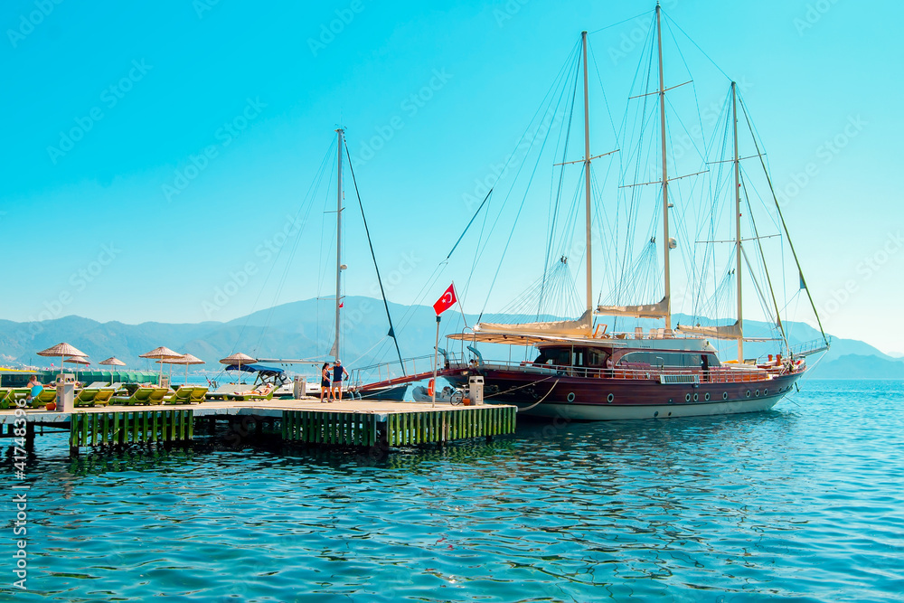 View of the Turkish port in the Mediterranean Sea in the city of Marmaris. Pier on a sunny summer day.