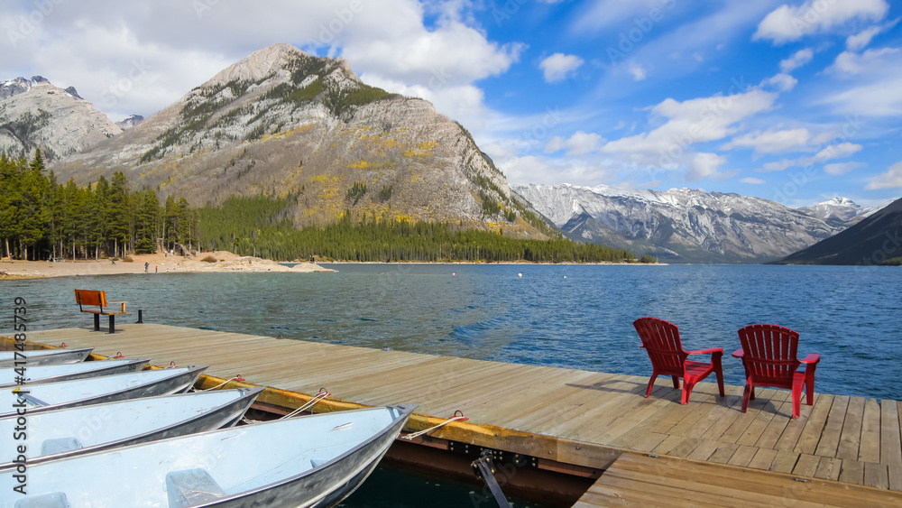 Canadian rocky mountains by Lake Minnewanka reservoir view from boating dock .