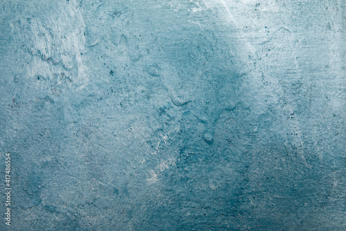 Painted different shades of blue on the wall. Abstract blue background