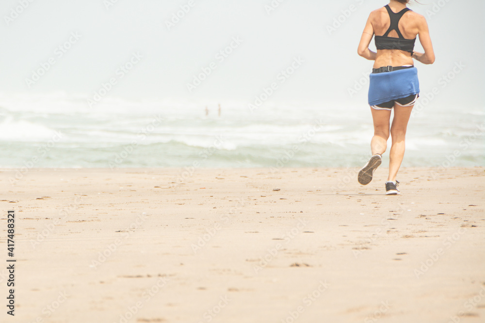 woman running doing physical exercises on the beach