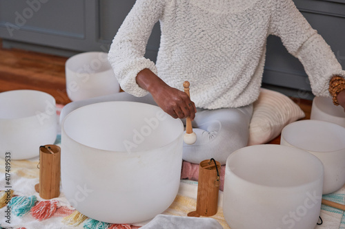 Black woman playing sound bath drums for mediation photo