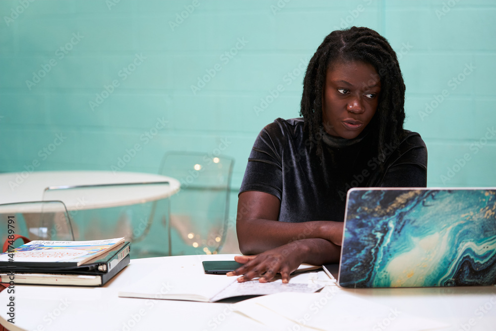 © Mhandy/Creative Flame - Black graphic design artist creative working on school project, on laptop