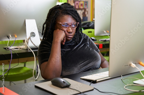 Black female college student bored in computer lab