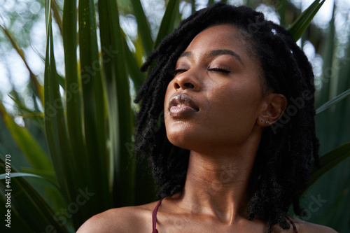 Portrait of confident African American woman with plants photo