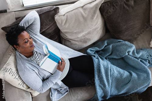 Black woman relaxed on couch at home, comfortable,sleep