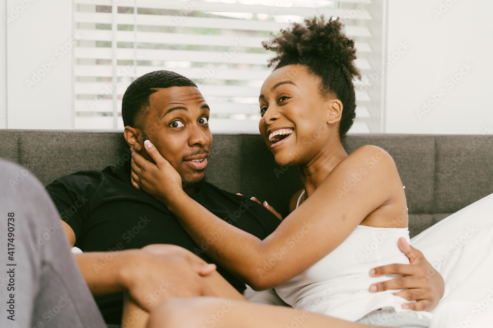 Young couple, boyfriend shocked and girlfriend laughing Young couple, boyfriend shocked and girlfriend laughing