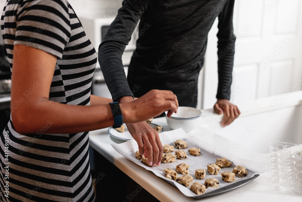 African American Mother and son preparing homemade baked cookies in kitchen African American Mother and son preparing homemade baked cookies in kitchen