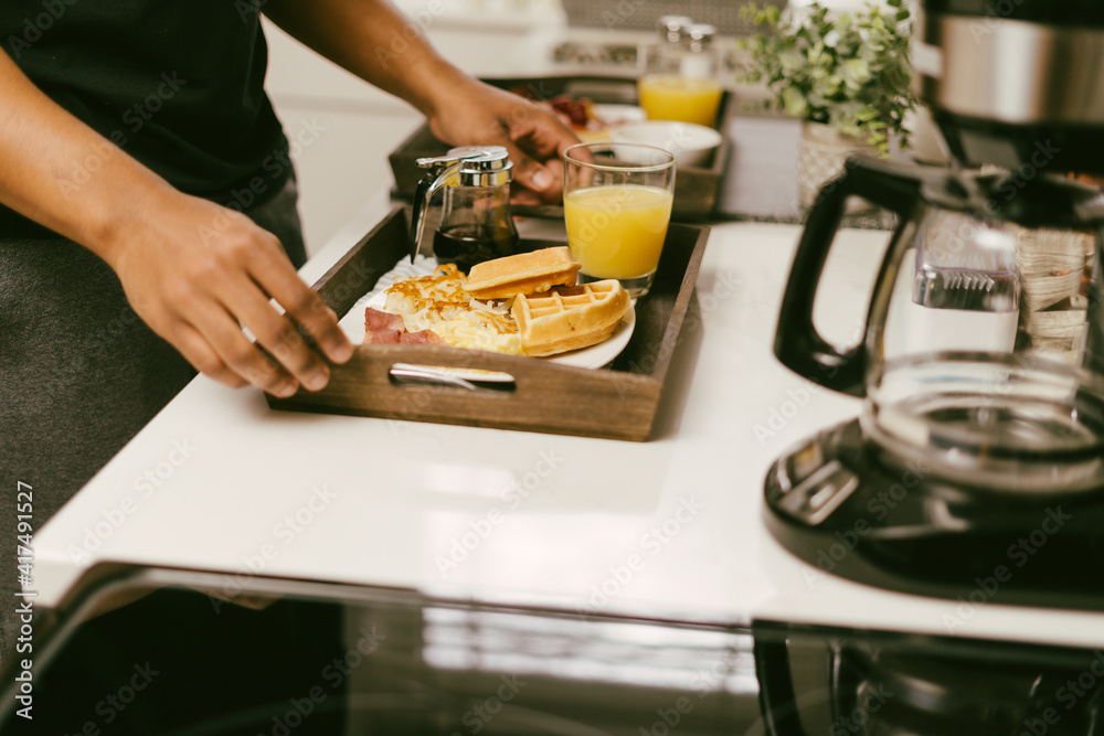 Boyfriend preparing breakfast for girlfriend, Young Black couple Boyfriend preparing breakfast for girlfriend, Young Black couple